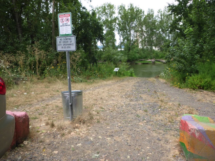 Path from parking lot to canoe/kayak launch - gravel surface - garbage can - sign: do not enter water